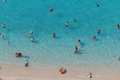 High angle view of people swimming in sea