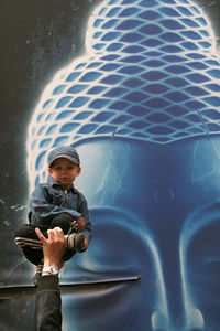 Full length of boy standing in water