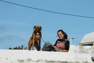 Portrait of woman standing against sky