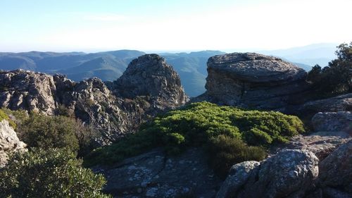 Scenic view of rocks and mountains against sky