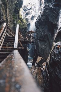 Footbridge by waterfall and rock formation