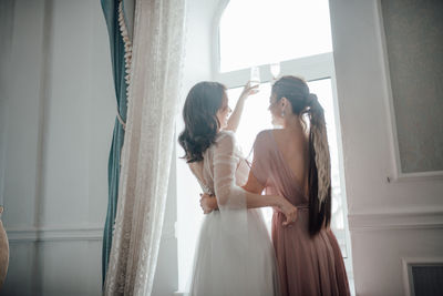 Women standing in corridor of building