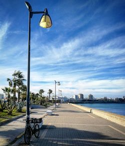 Street lights in city against sky