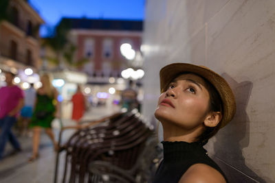 Portrait of young woman looking away outdoors