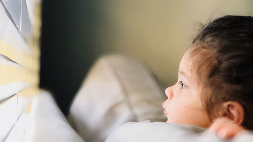 Close-up of boy sleeping on bed at home