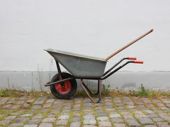 Side view of motorcycle against red wall