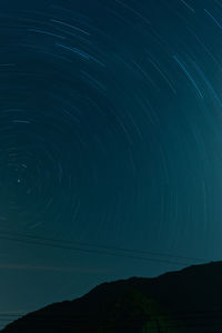 Low angle view of star trail against sky at night