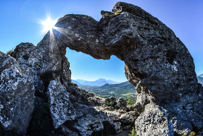 Low angle view of rock formation against sky