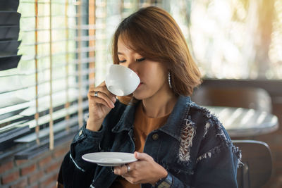 Woman holding coffee cup