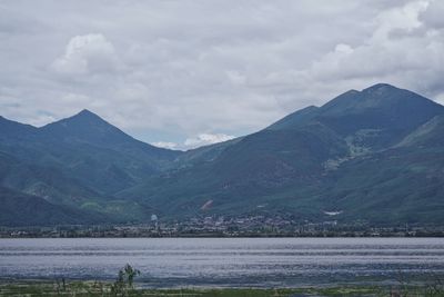 Scenic view of lake and mountains against sky