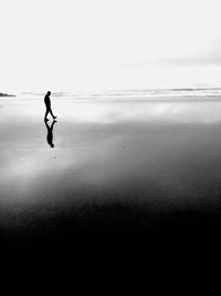 Full length of man on beach against sky