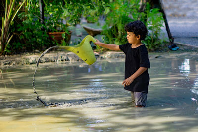 Boy standing in water