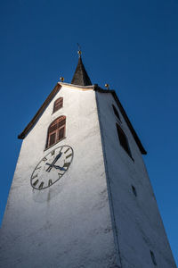 Low angle view of building against clear blue sky