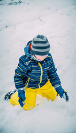 Boy playing on snow field