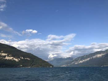 Scenic view of sea and mountains against sky