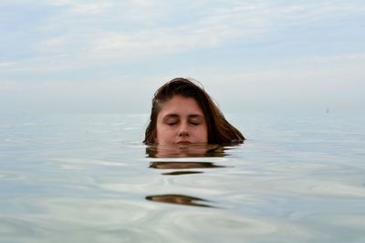 Portrait of man in swimming pool against sky