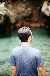 Rear view of man looking at sea