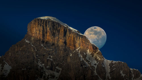 Low angle view of rock formation against sky at night