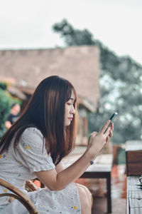 Young woman using mobile phone outdoors