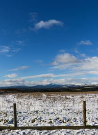 Scenic view of snow covered mountains against sky