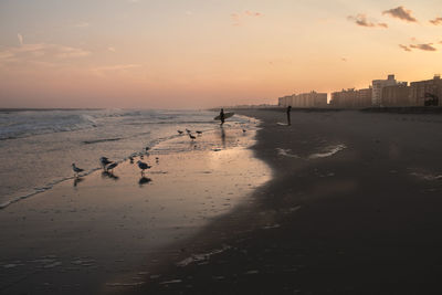 Scenic view of beach against sky during sunset