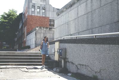 Woman standing in front of building