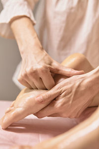 Hands of woman doing massage on leg