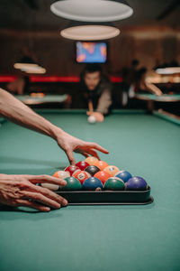 Cropped hand playing pool