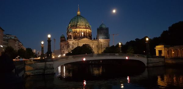 Reflection of illuminated buildings in water at night