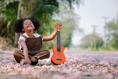 Happy girl playing with arms raised