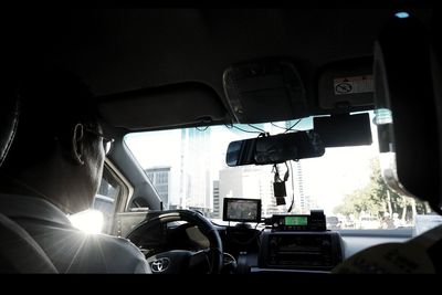 Rear view of man driving car