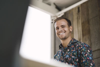 Low angle view of young businessman smiling in portable office truck