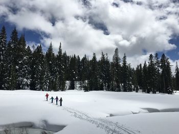 High angle view of people hiking on snow covered landscape