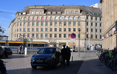 People on street against buildings in city