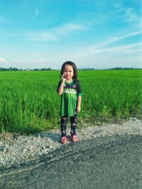 Full length portrait of girl on field