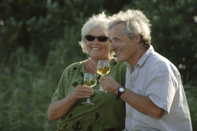 Happy senior couple having drink outdoors