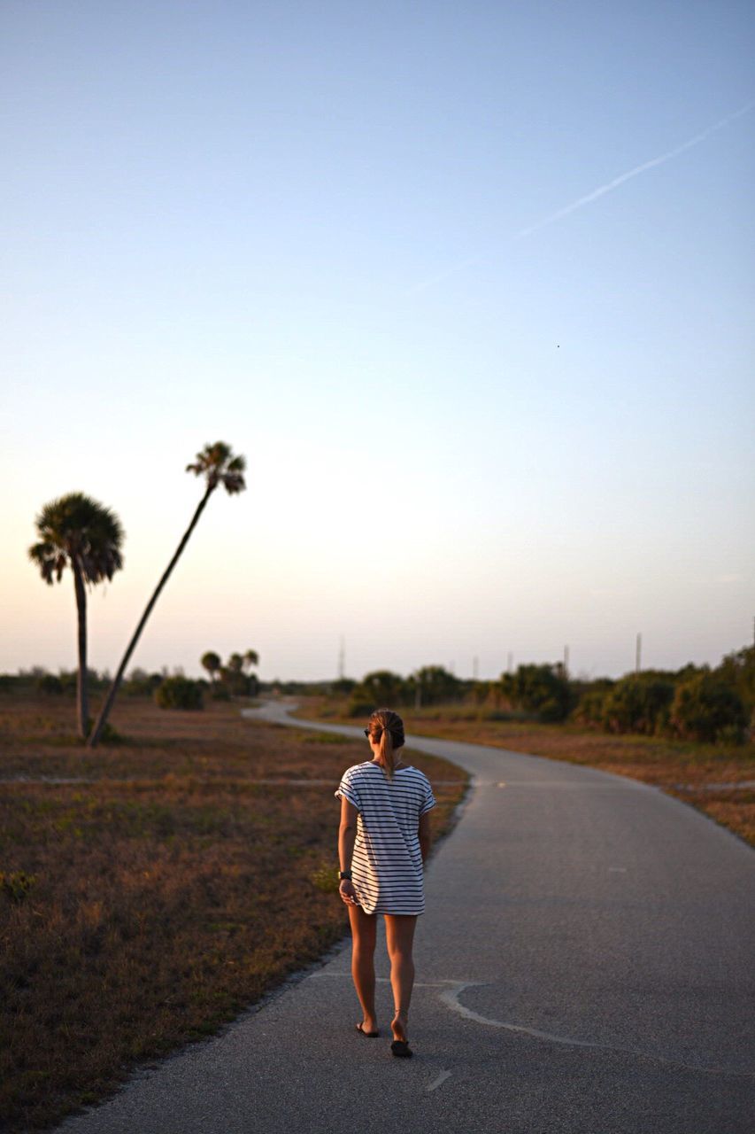 WOMAN WALKING ON ROAD