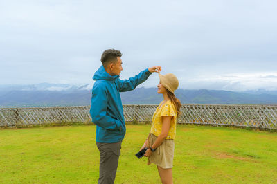 Young couple standing at the hill with loving emotion ,love and relationship concept