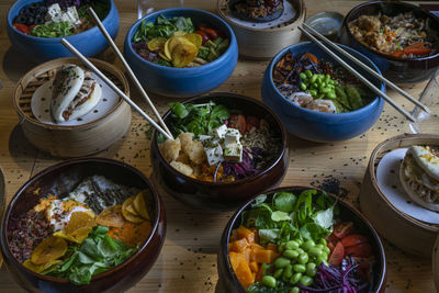 Bowls of poke in colorful bowls on a wooden background