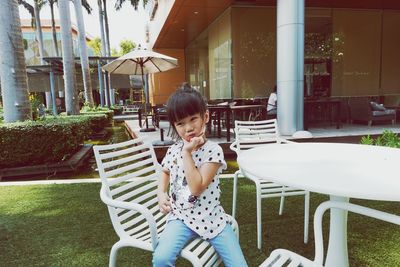 Portrait of girl sitting on chair