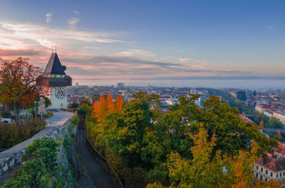 Cityscape of graz and the famous clock tower on shlossberg hill, graz, styria , austria, in autumn.