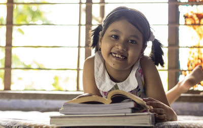 Portrait of smiling girl with book