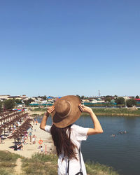 Rear view of woman on beach against 