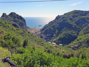 Scenic view of mountains and sea against sky