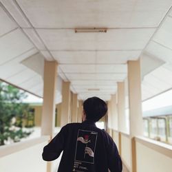 Rear view of woman standing in building