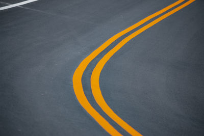 High angle view of yellow road sign on street