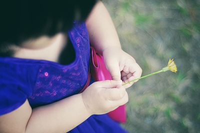 Close-up of cropped hand holding object over white background