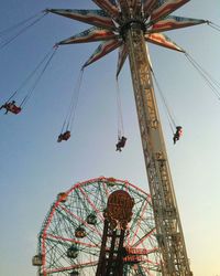 Low angle view of ferris wheel against sky