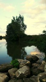 Scenic view of lake against cloudy sky