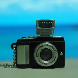 Close-up of camera against blue background